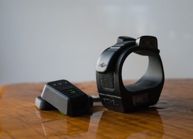 TENZR wristband sitting on wooden table
