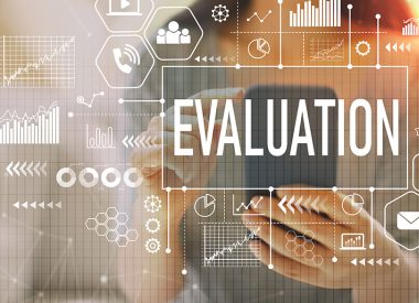 Image of woman holding a smartphone with icons and the word "evaluation"